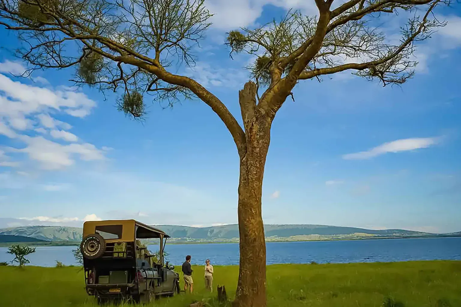 Safari vehicle beside a lake on a game drive in Akagera National Park