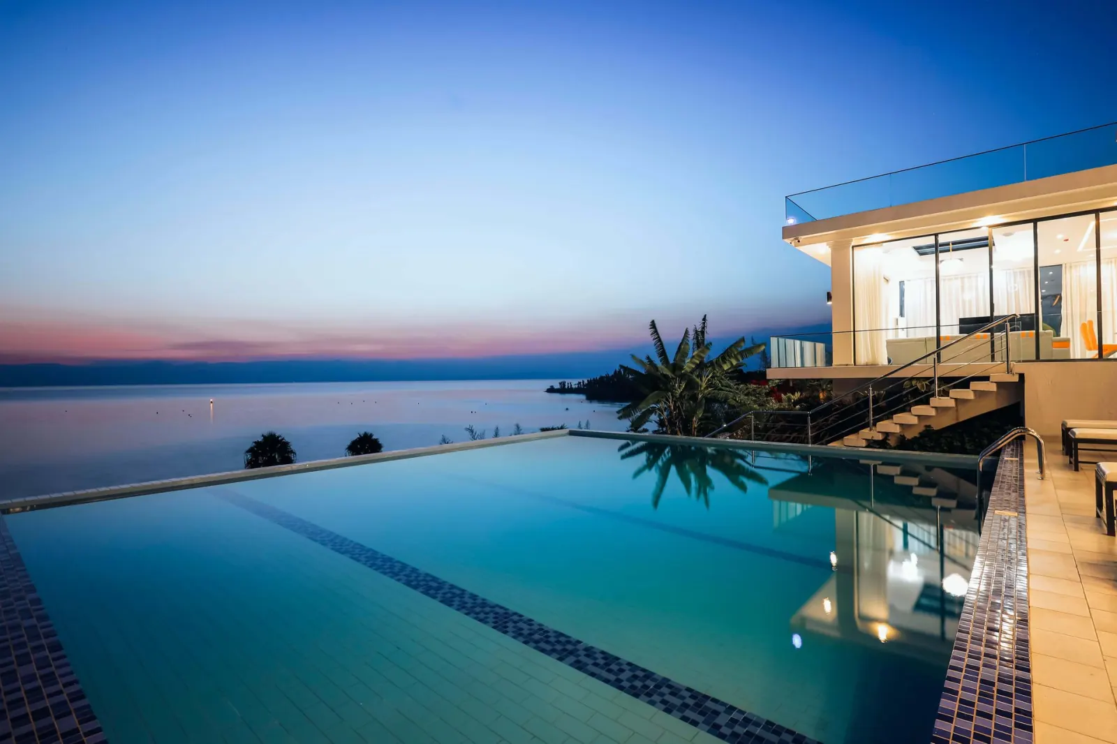 Infinity pool at B&P Ever Retreat Villa above Lake Kivu at dusk