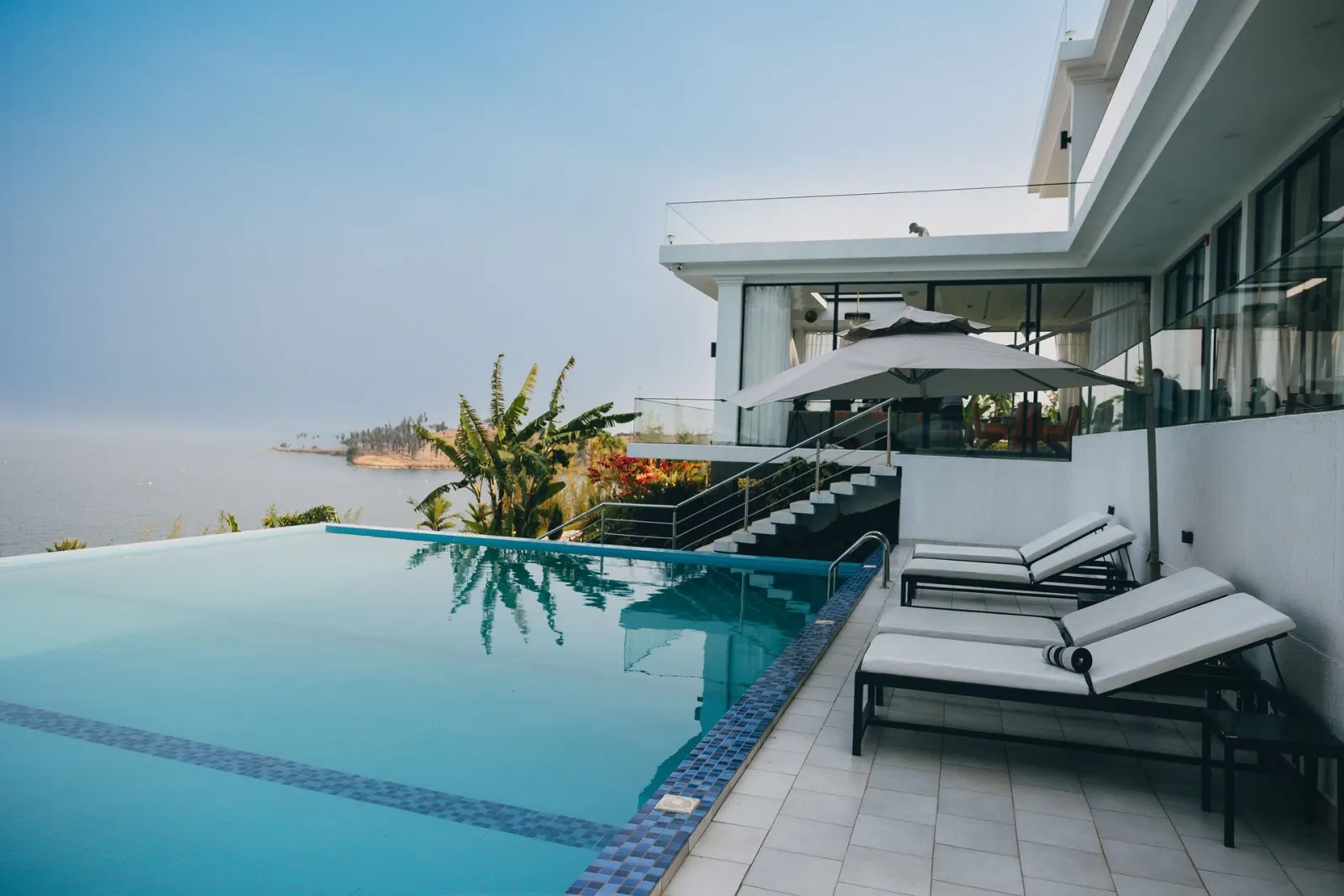 Sun loungers beside the infinity pool at B&P Ever Retreat Villa, Lake Kivu