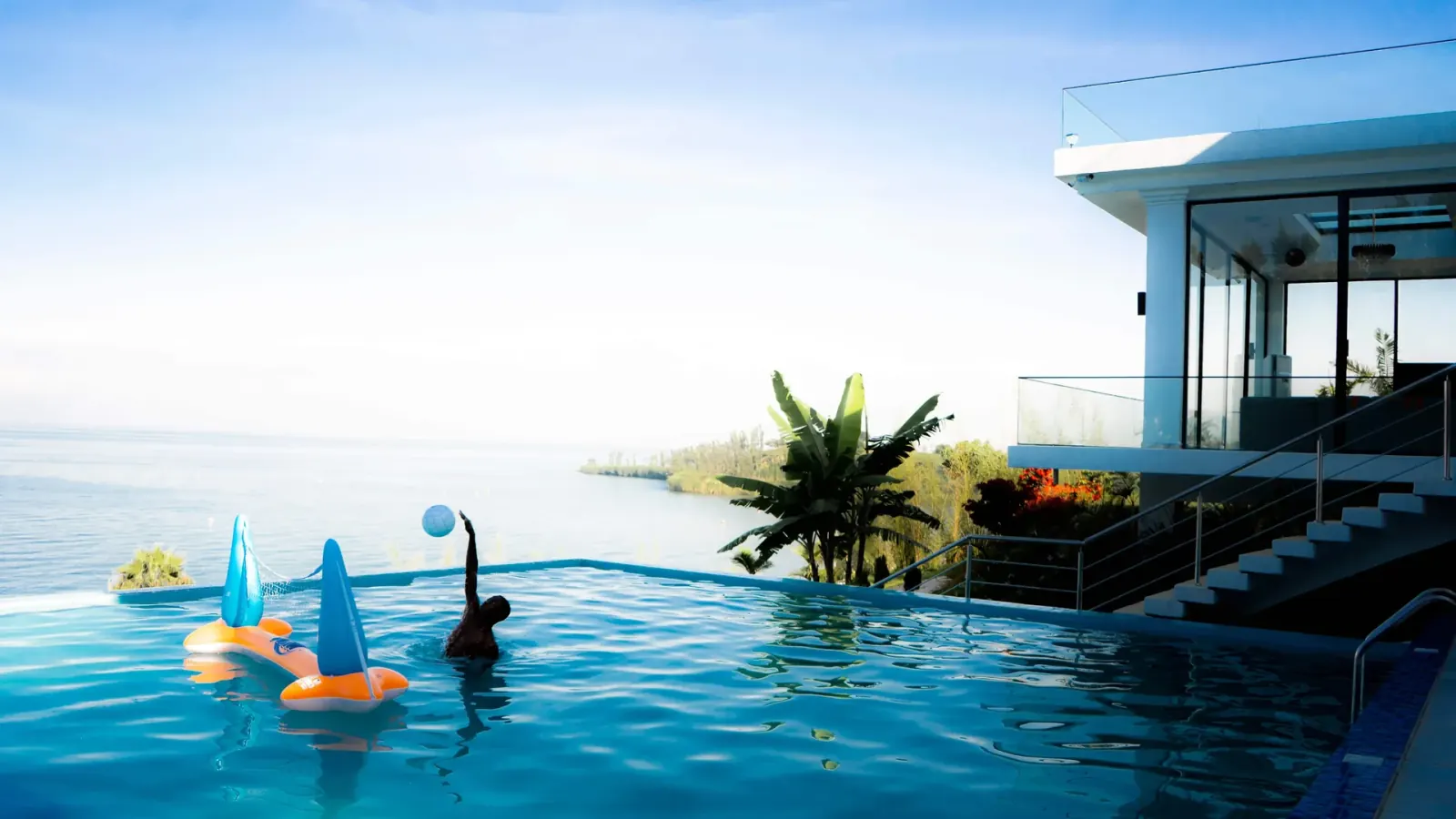 Guest swimming in the infinity pool at B&P Ever Retreat Villa above Lake Kivu